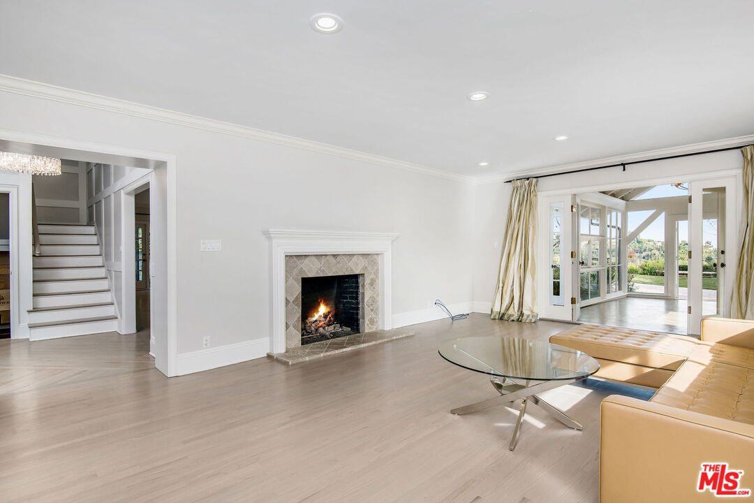 1110 Stradella Road Los Angeles, CA 90077 - Photo 10 of 26 a living room with furniture and a fireplace