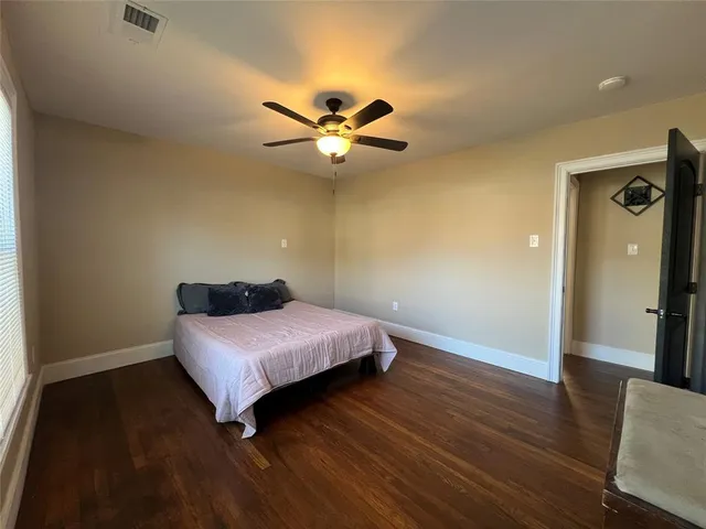 a bedroom with a bed and a ceiling fan