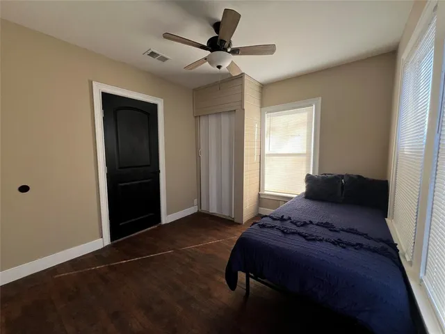 a bedroom with a bed and a ceiling fan