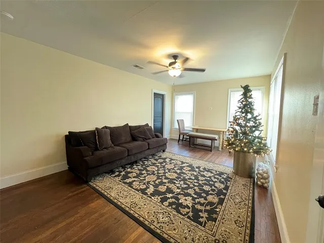 a living room with a couch and a chandelier