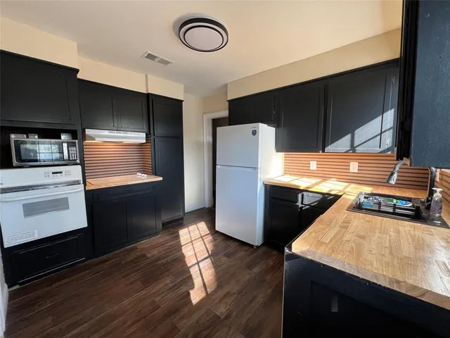 a kitchen with refrigerator and stove