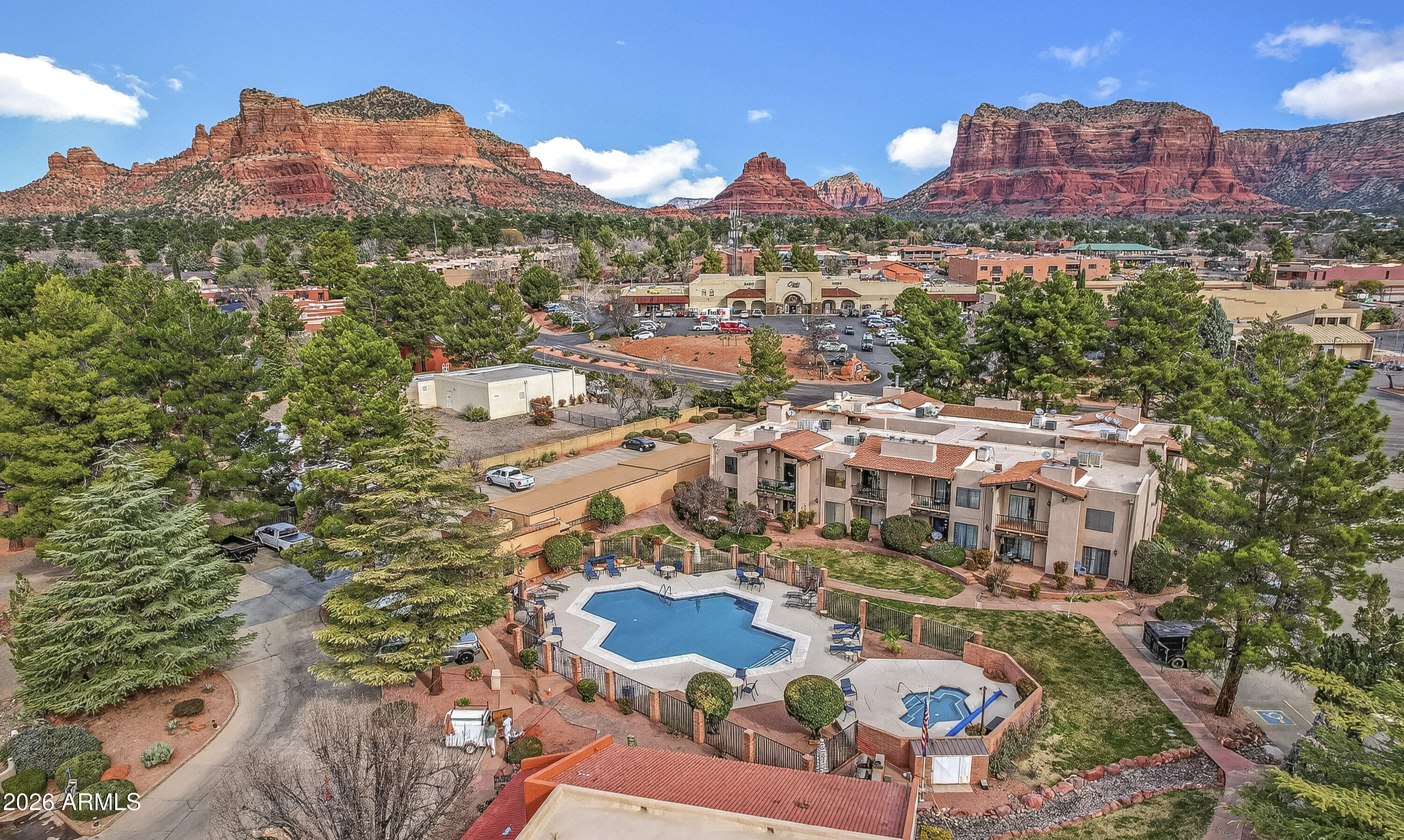 an aerial view of residential houses with outdoor space and street view