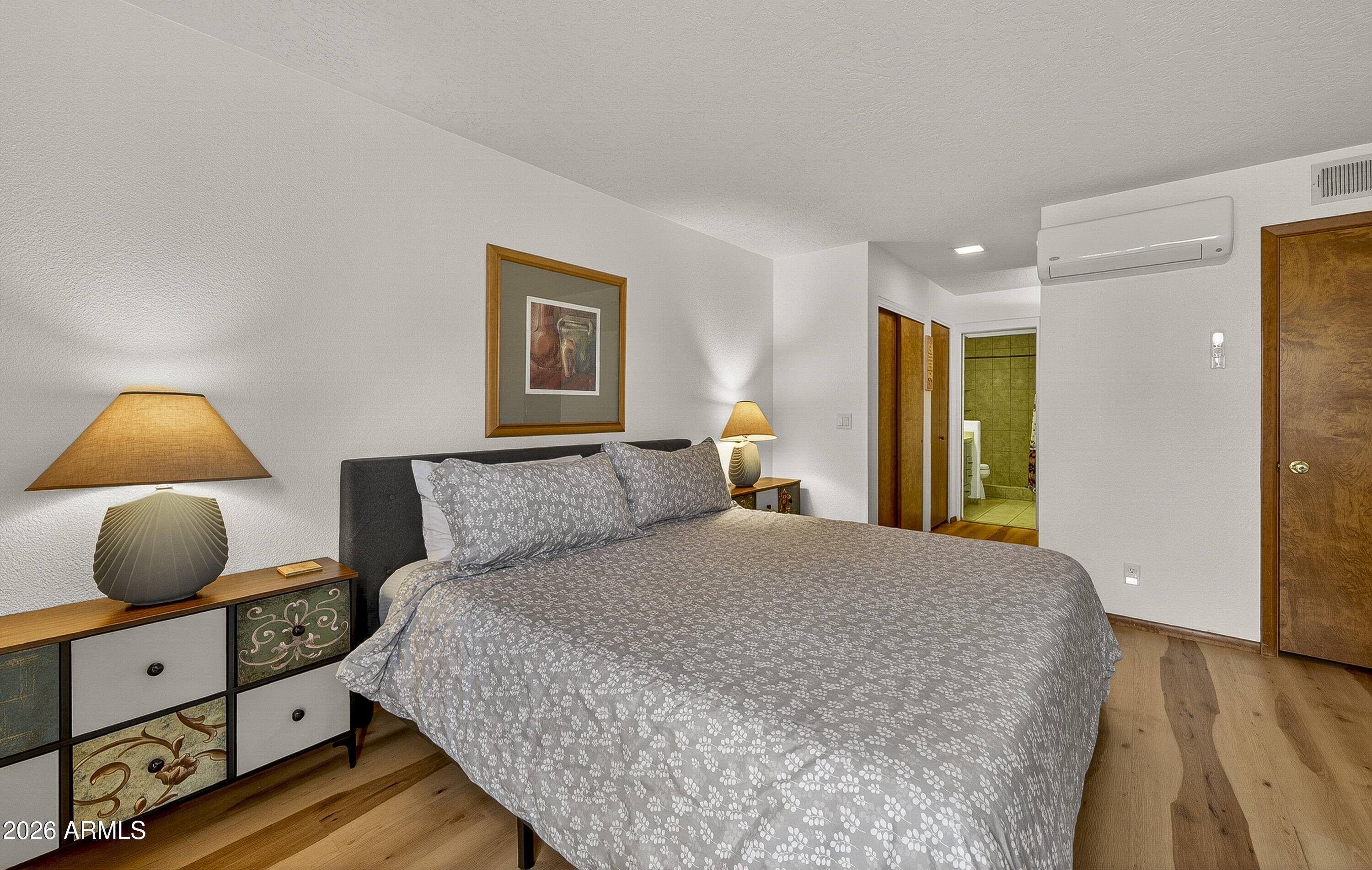 65 Verde Valley School Road, Unit E3 Sedona, AZ 86351 - Photo 11 of 24 a bedroom with a bed and wooden floor