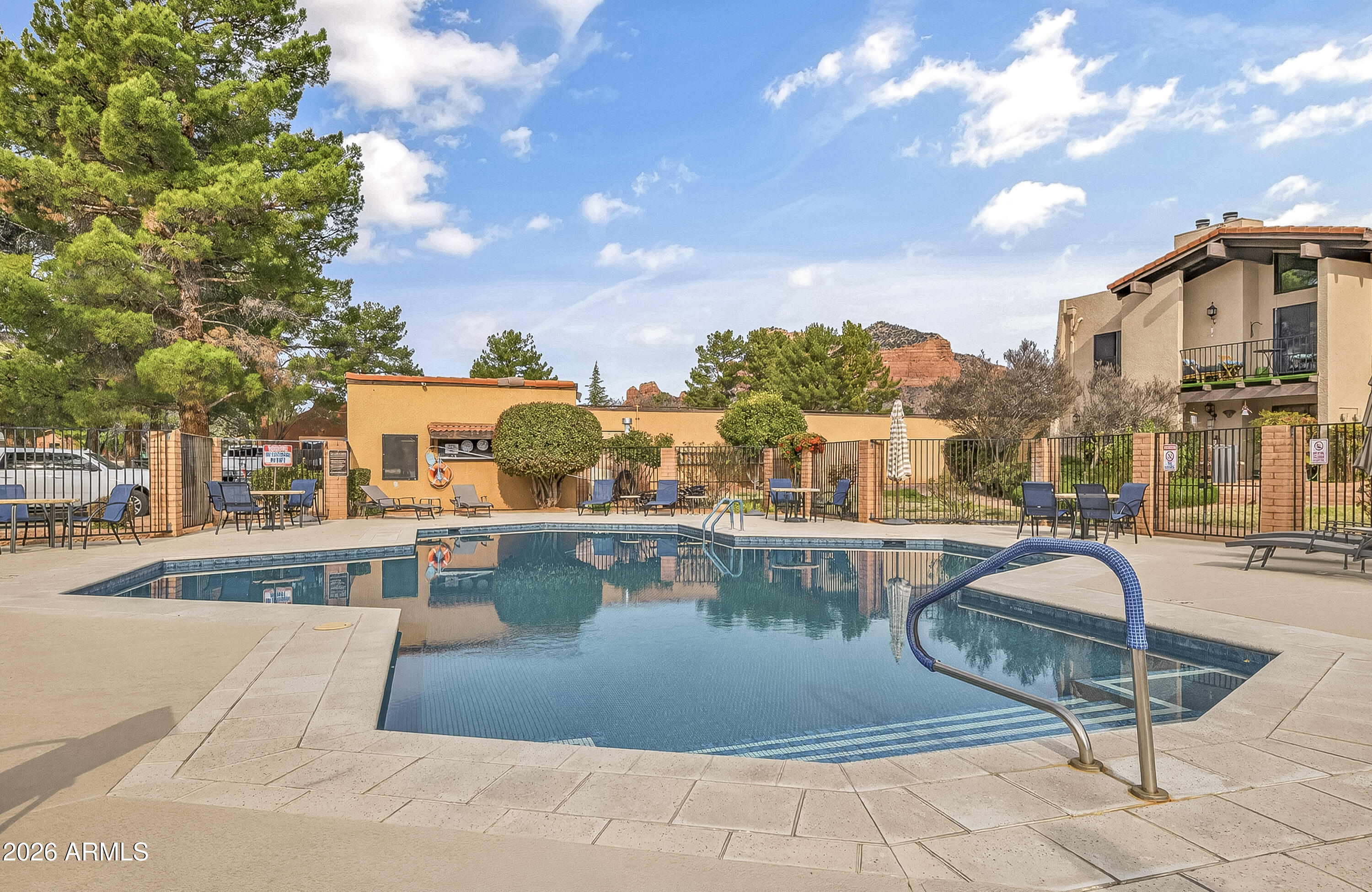 65 Verde Valley School Road, Unit E3 Sedona, AZ 86351 - Photo 16 of 24 a view of a swimming pool with outdoor seating