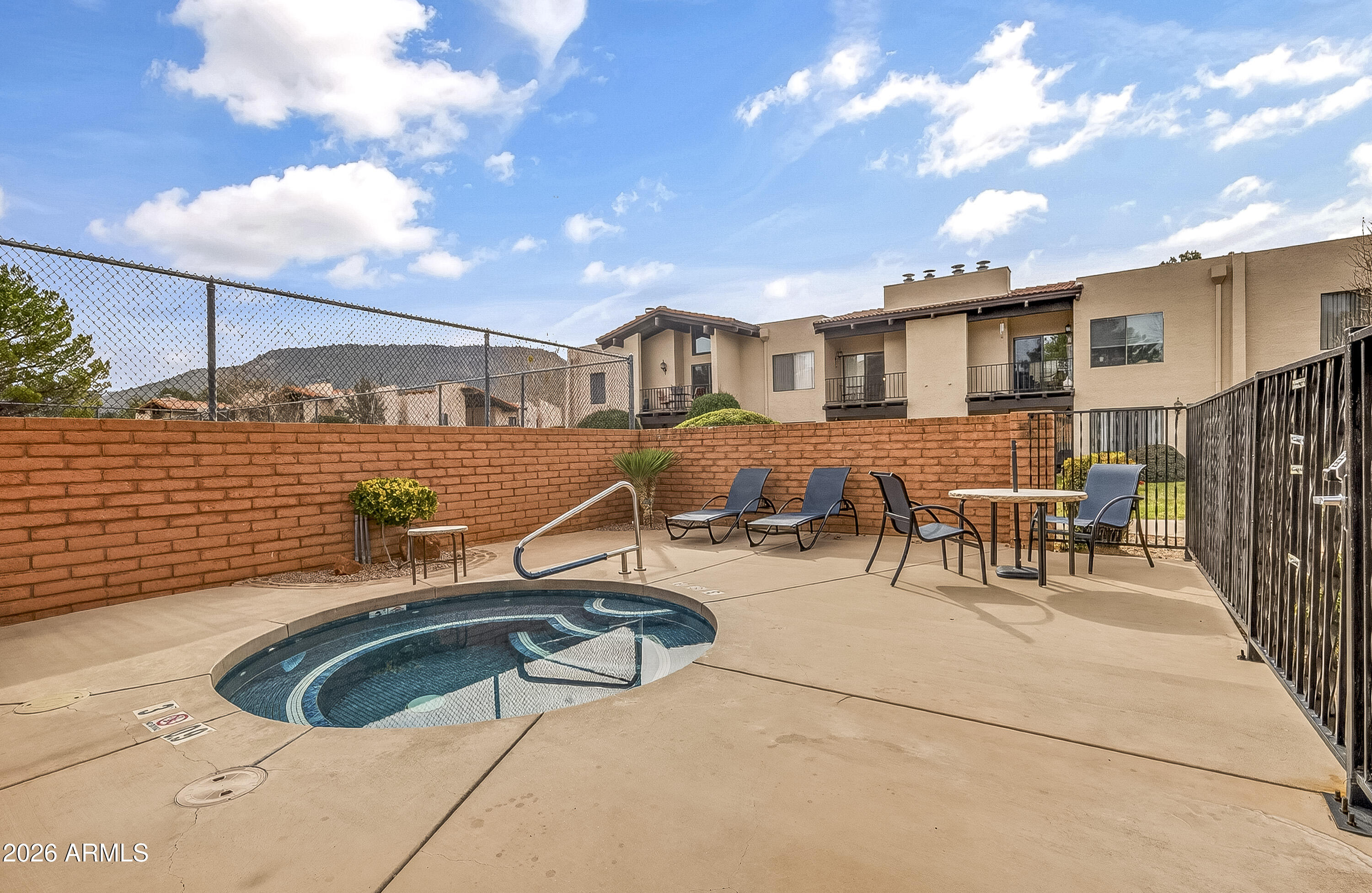 65 Verde Valley School Road, Unit E3 Sedona, AZ 86351 - Photo 18 of 24 a view of a patio with couches table and chairs with wooden floor