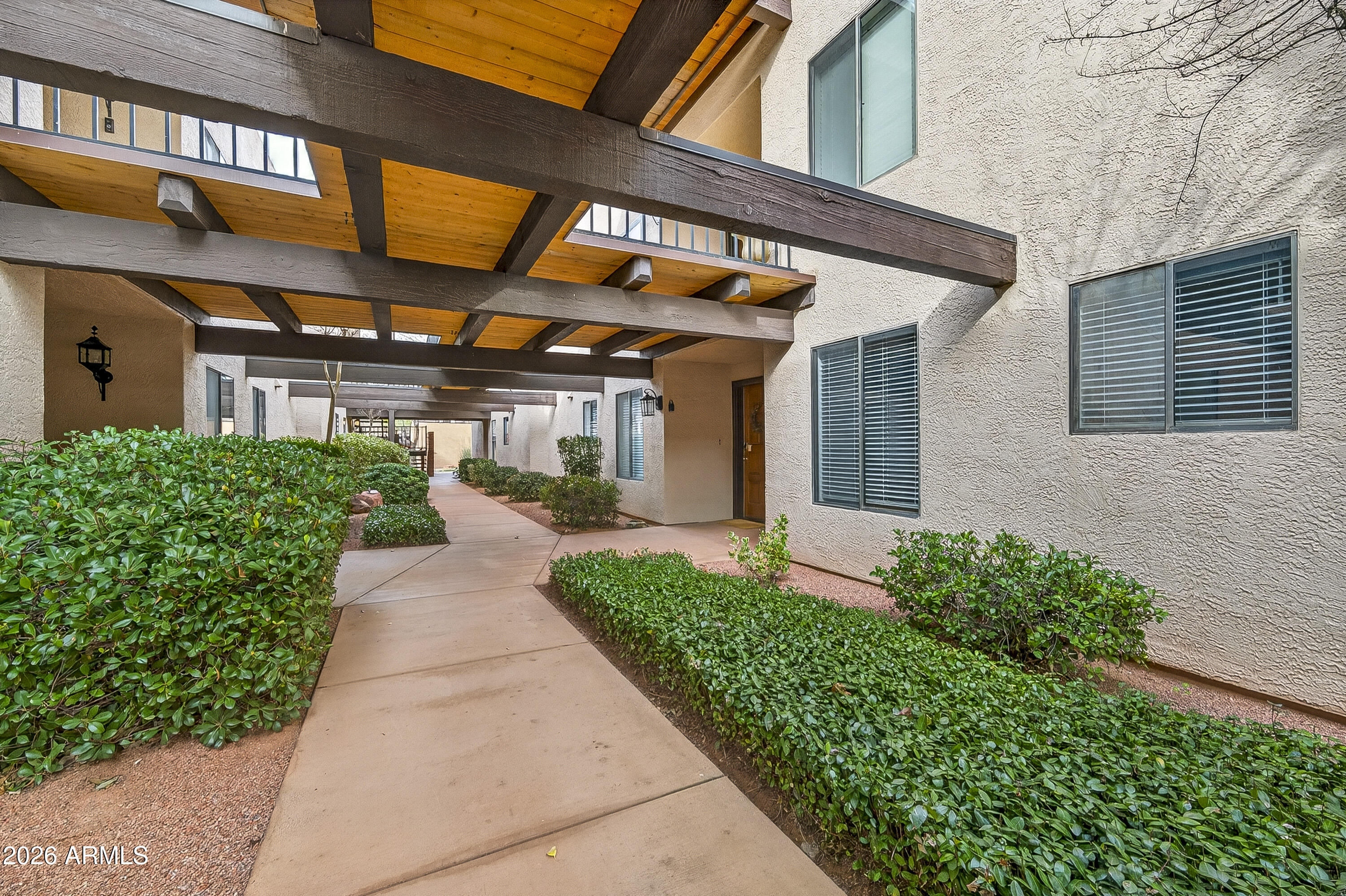 65 Verde Valley School Road, Unit E3 Sedona, AZ 86351 - Photo 21 of 24 a front view of a house with a yard and trees