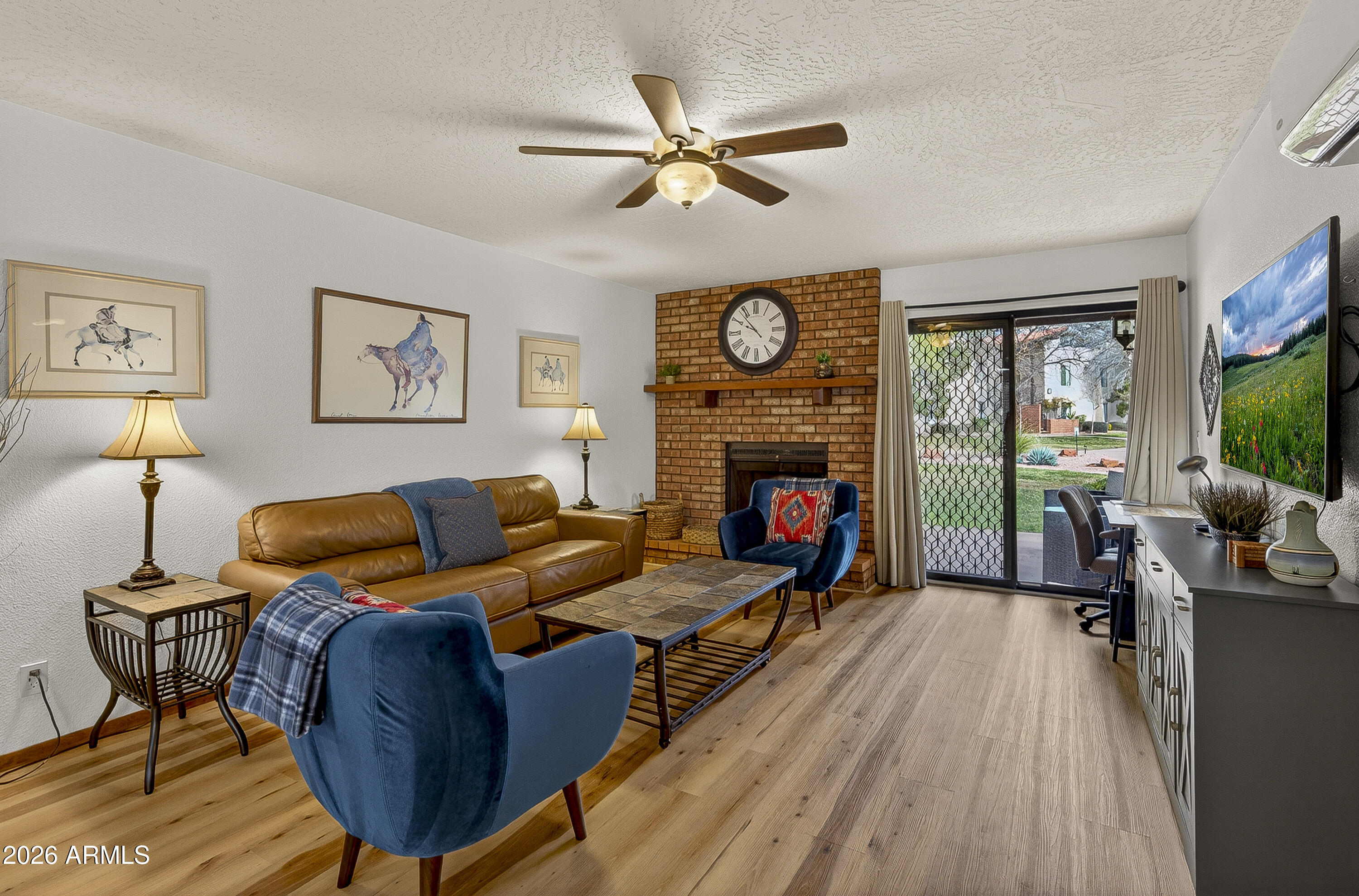 65 Verde Valley School Road, Unit E3 Sedona, AZ 86351 - Photo 4 of 24 a living room with furniture fireplace and a large window
