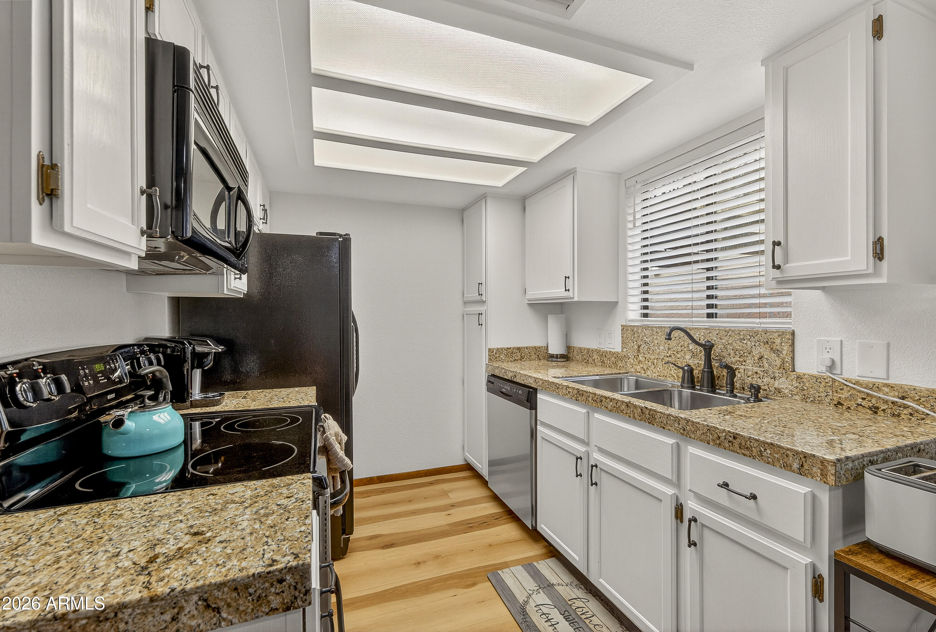 65 Verde Valley School Road, Unit E3 Sedona, AZ 86351 - Photo 5 of 24 a kitchen with stainless steel appliances granite countertop a stove and a sink