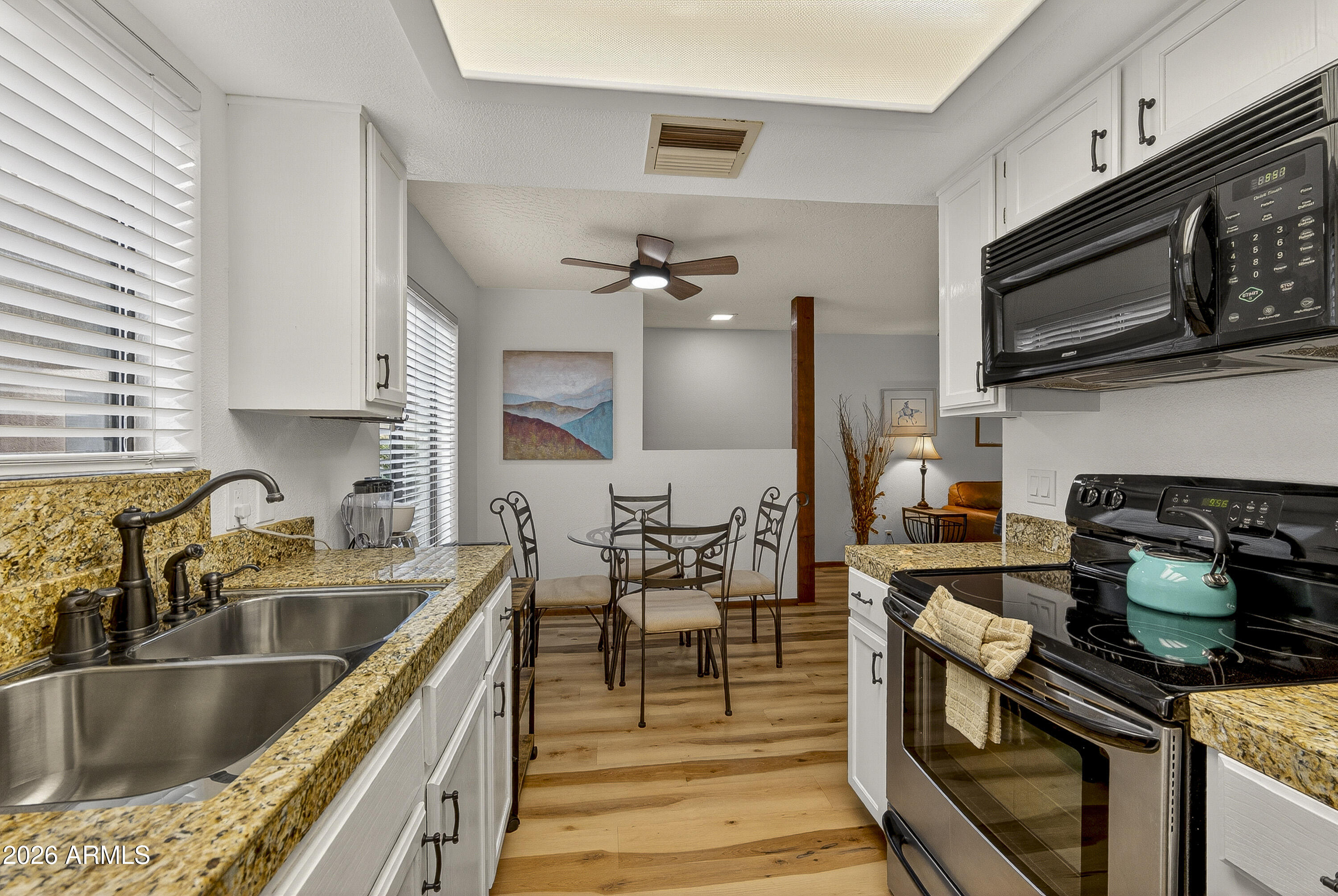 65 Verde Valley School Road, Unit E3 Sedona, AZ 86351 - Photo 6 of 24 a kitchen with stainless steel appliances a stove sink microwave and cabinets