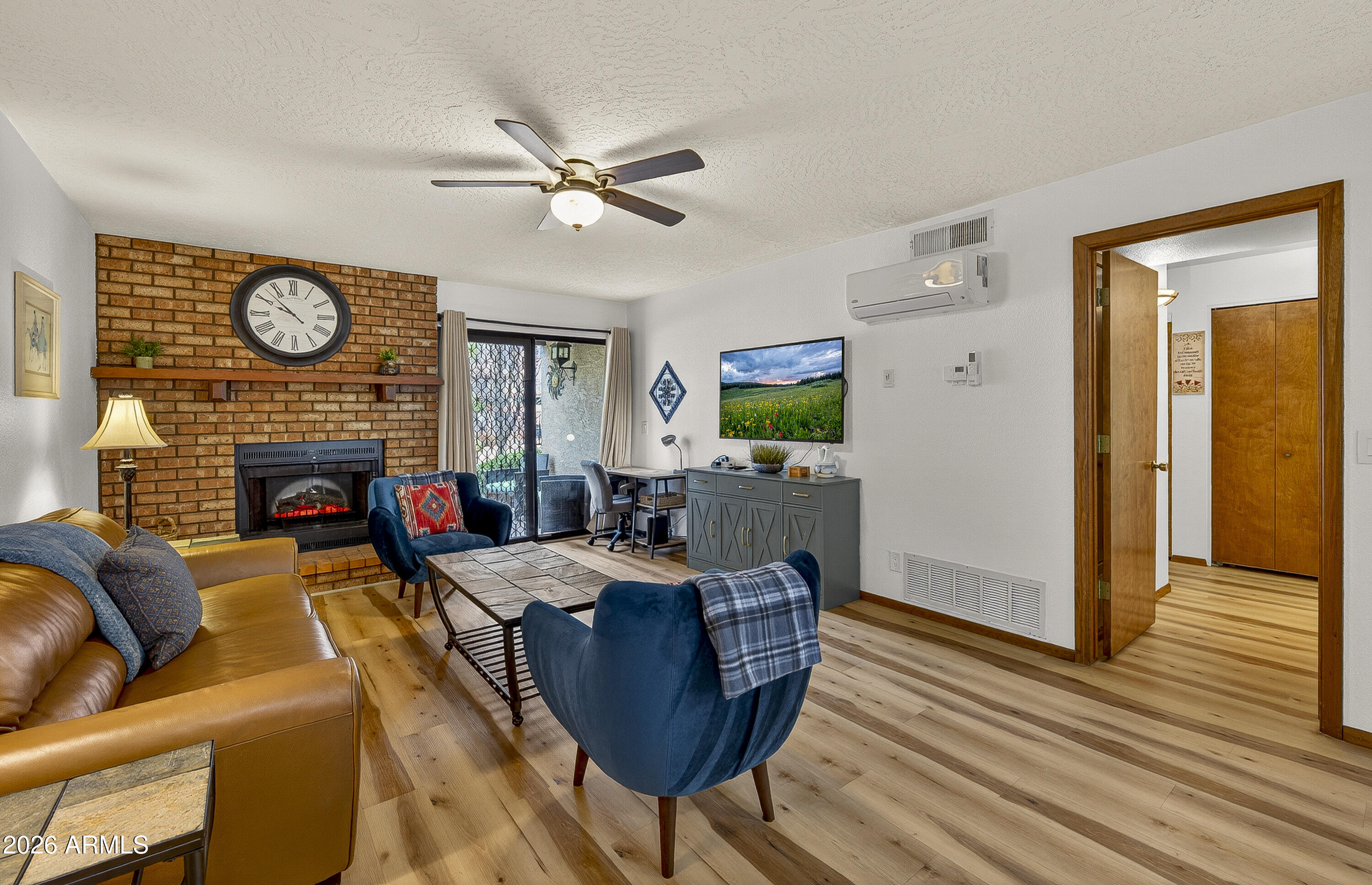 65 Verde Valley School Road, Unit E3 Sedona, AZ 86351 - Photo 9 of 24 a living room with furniture a fireplace and a table