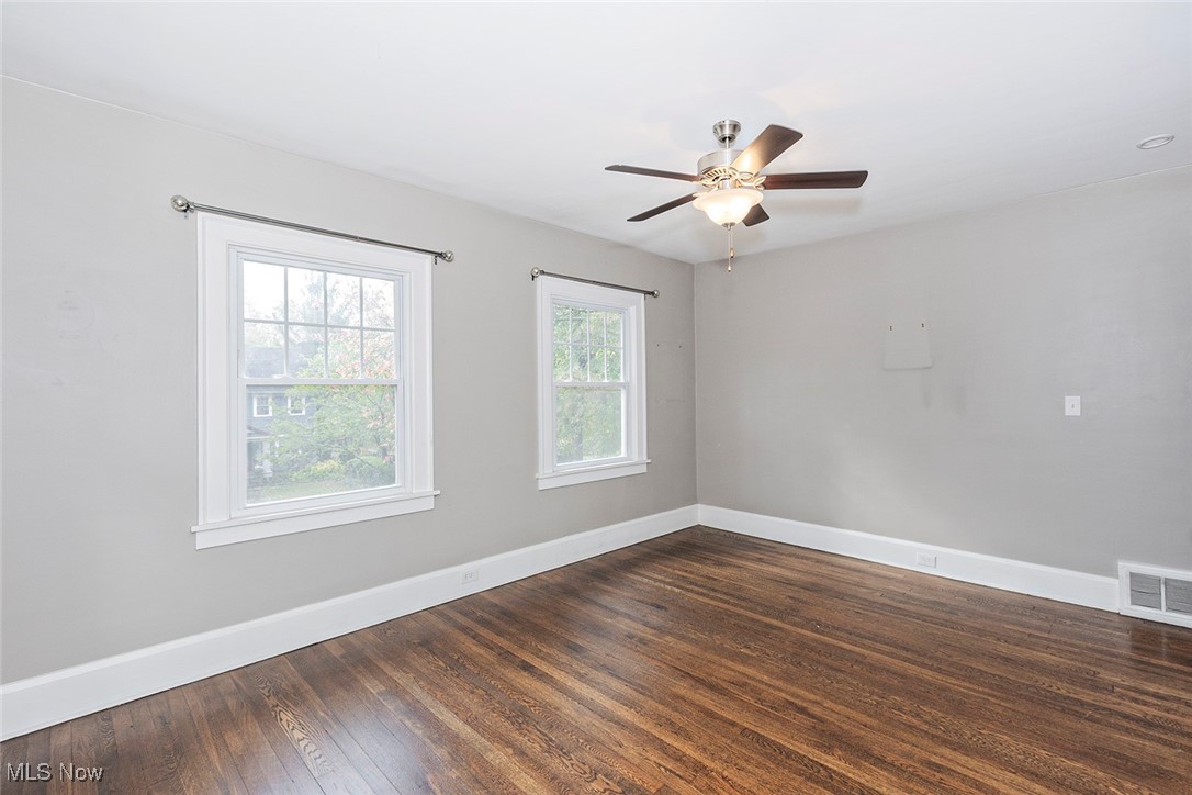 2875 Coleridge Road Cleveland, OH 44118 - Photo 21 of 37 Spare room with dark wood-style floors and ceiling fan