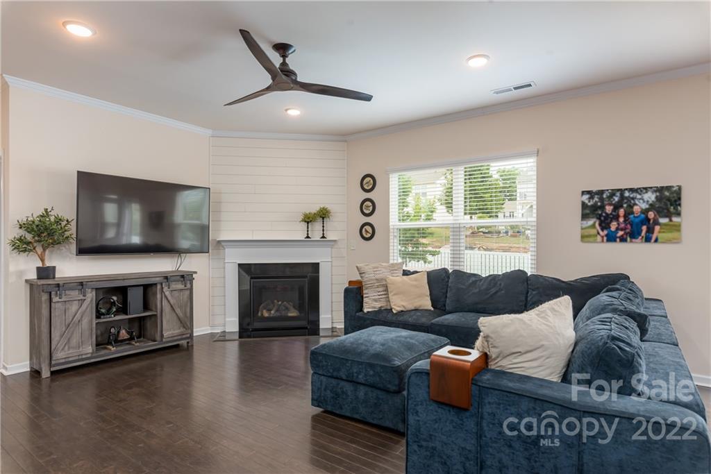 239 Keating Pl Drive Fort Mill, SC 29708 - Photo 12 of 33 a living room with furniture a flat screen tv and a fireplace