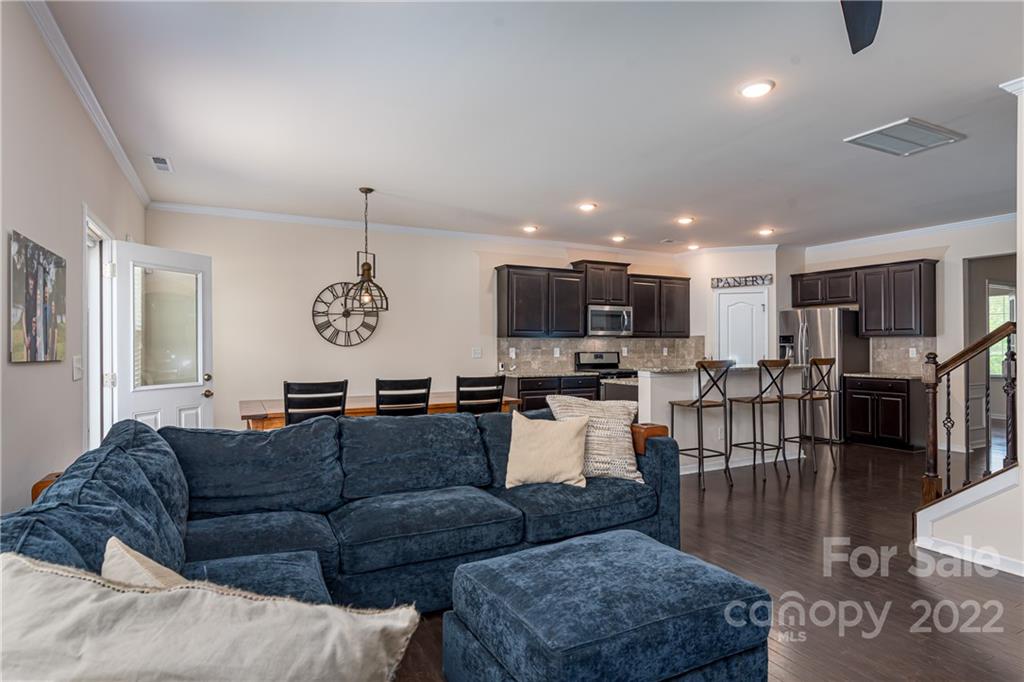 239 Keating Pl Drive Fort Mill, SC 29708 - Photo 14 of 33 a living room with furniture kitchen view and a wooden floor