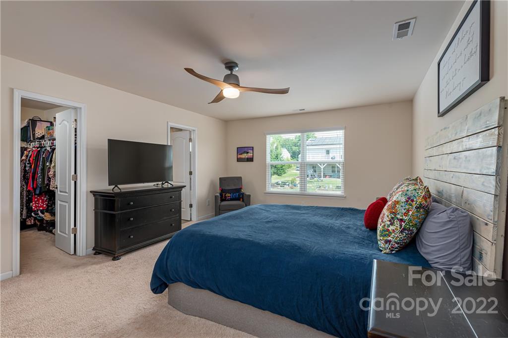 239 Keating Pl Drive Fort Mill, SC 29708 - Photo 21 of 33 a spacious bedroom with a bed and a flat screen television