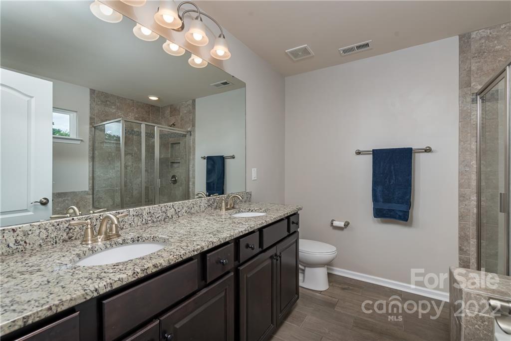 239 Keating Pl Drive Fort Mill, SC 29708 - Photo 22 of 33 a bathroom with a granite countertop sink a large mirror and toilet