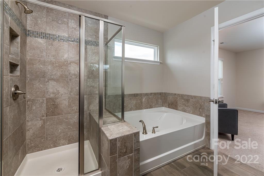 239 Keating Pl Drive Fort Mill, SC 29708 - Photo 23 of 33 a bathroom with a bathtub and shower