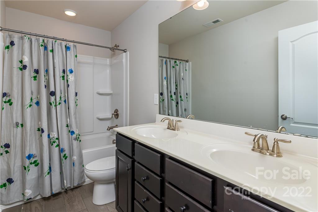 239 Keating Pl Drive Fort Mill, SC 29708 - Photo 27 of 33 a bathroom with a granite countertop sink toilet and shower