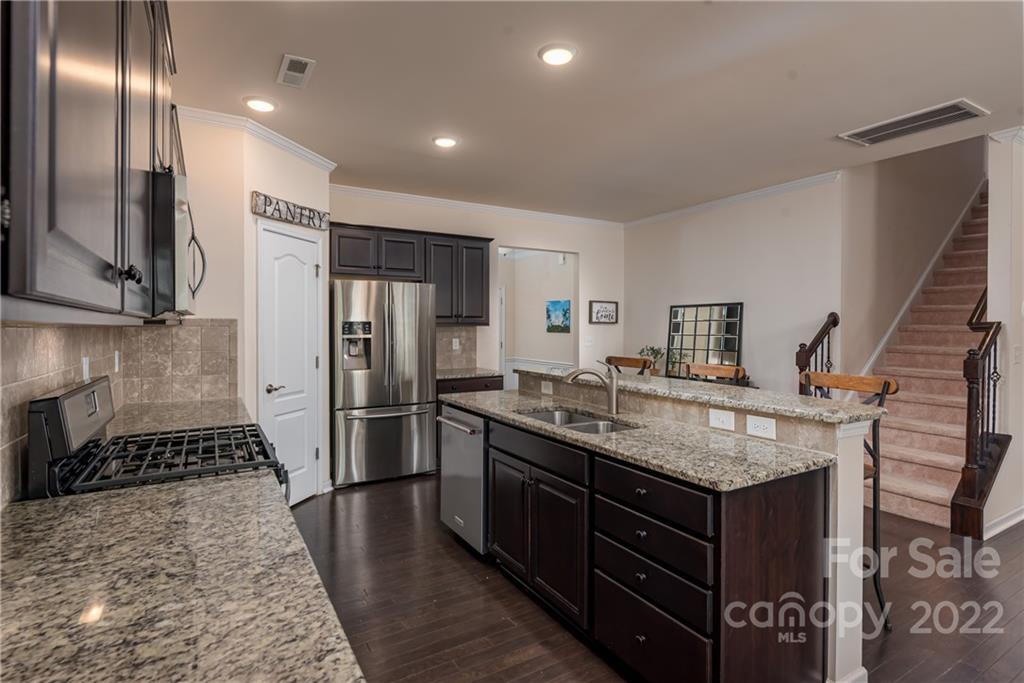 239 Keating Pl Drive Fort Mill, SC 29708 - Photo 9 of 33 a kitchen with a refrigerator and a sink