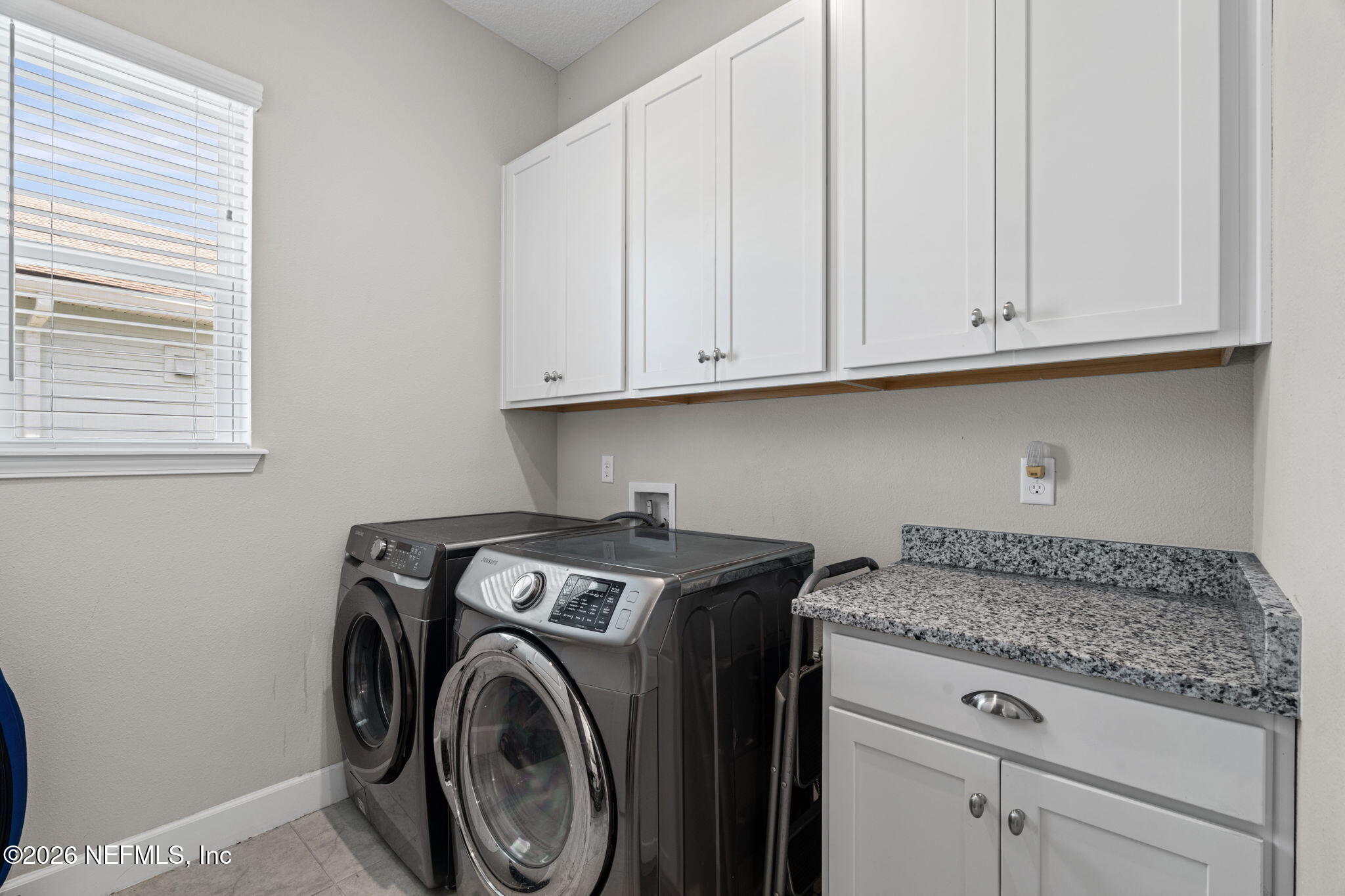 813 Rustic Mill Dr Street St. Augustine, FL 32092 - Photo 13 of 57 a utility room with granite countertop cabinets washer and dryer