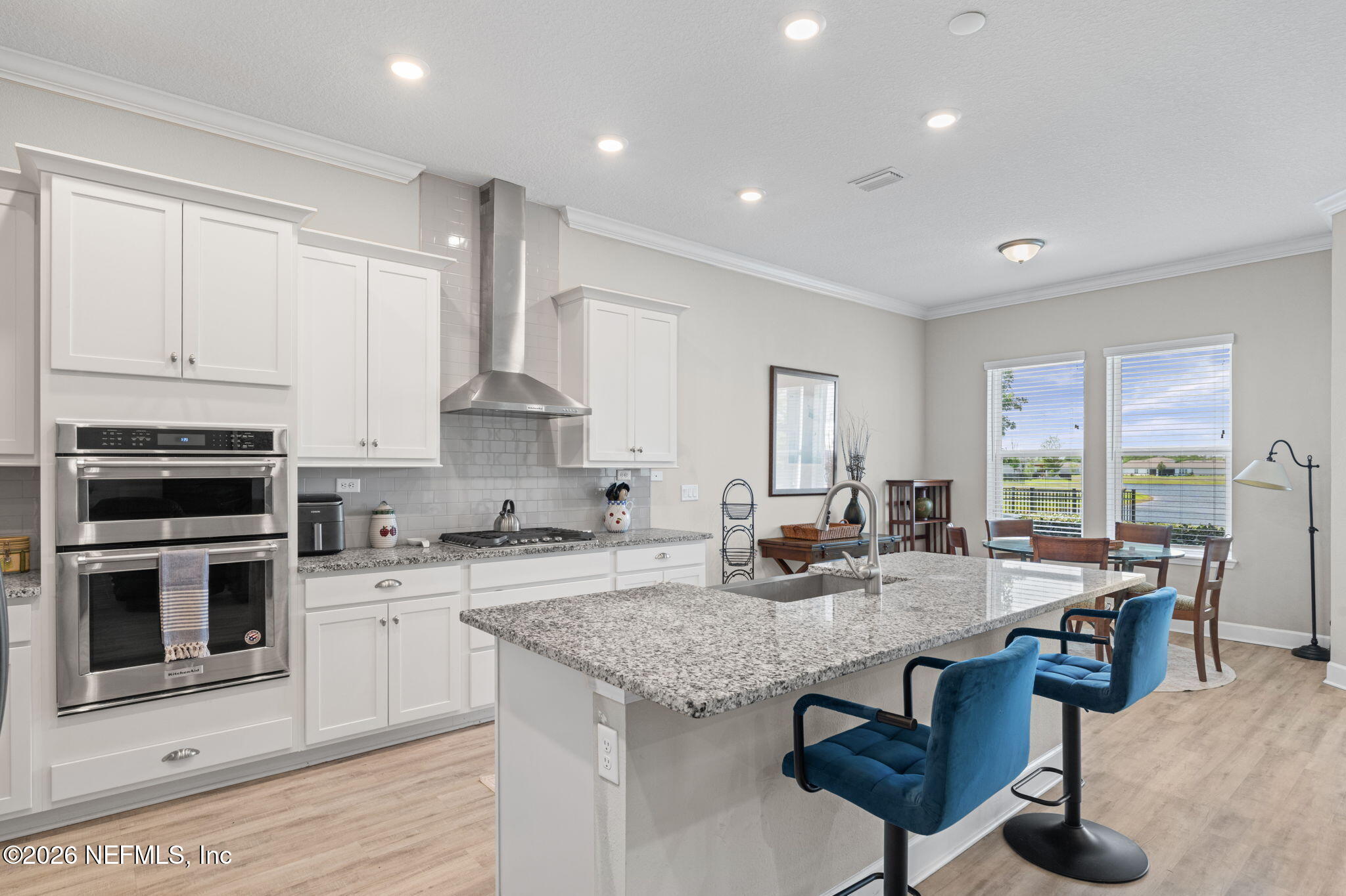 813 Rustic Mill Dr Street St. Augustine, FL 32092 - Photo 19 of 57 a kitchen with granite countertop kitchen island wooden cabinets and stainless steel appliances