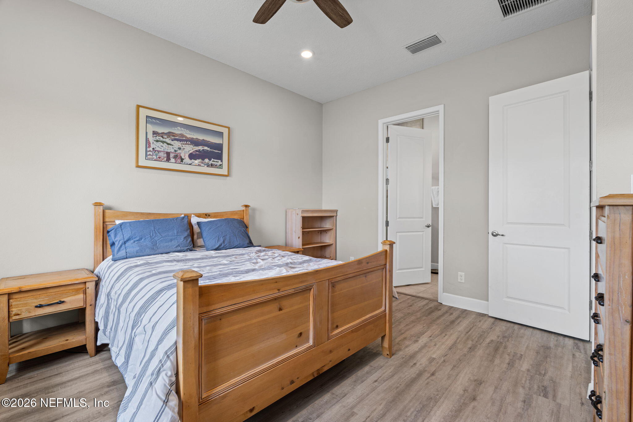 813 Rustic Mill Dr Street St. Augustine, FL 32092 - Photo 23 of 57 a bedroom with a bed and a chandelier