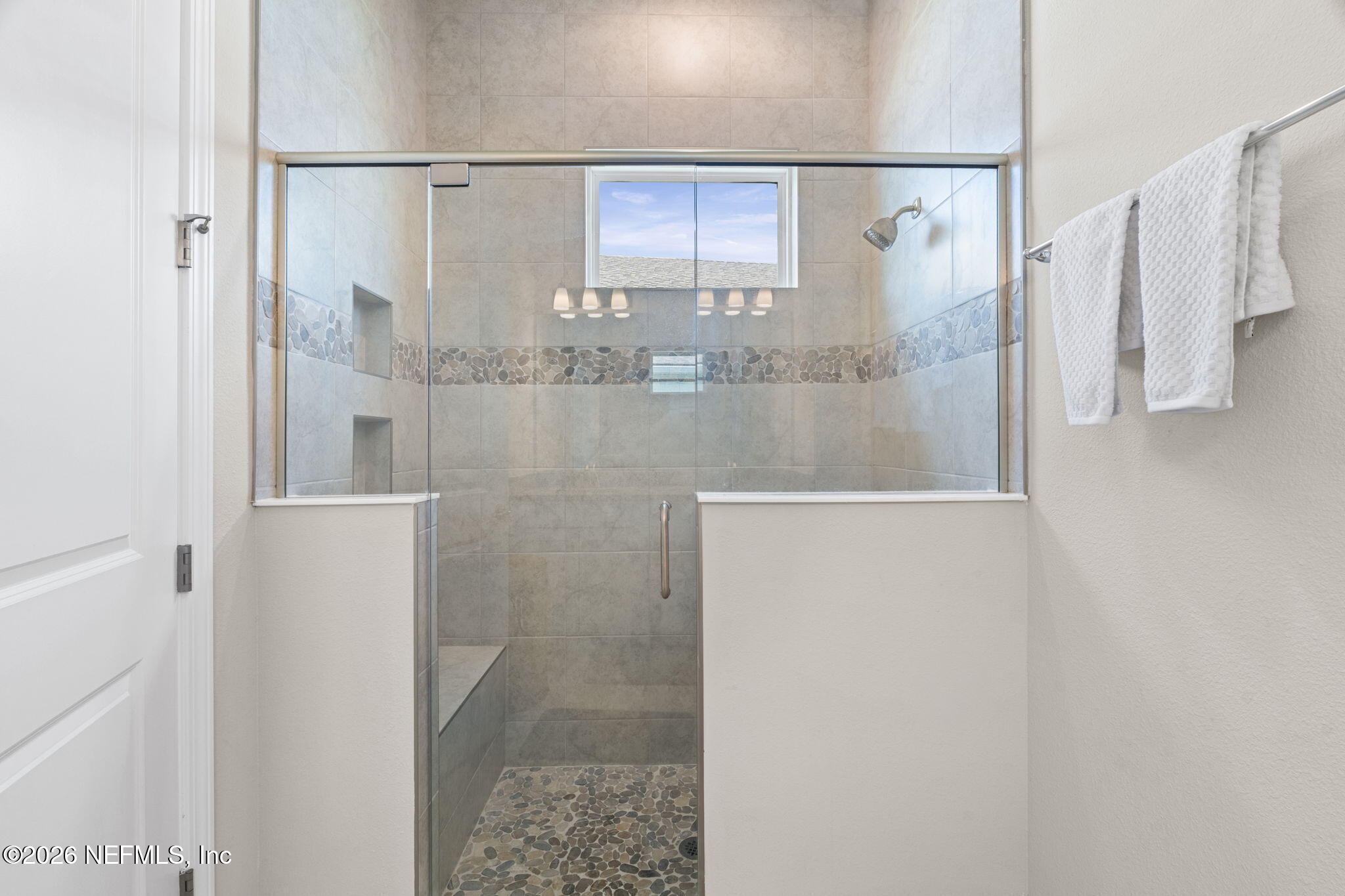 813 Rustic Mill Dr Street St. Augustine, FL 32092 - Photo 25 of 57 a bathroom with a glass shower door