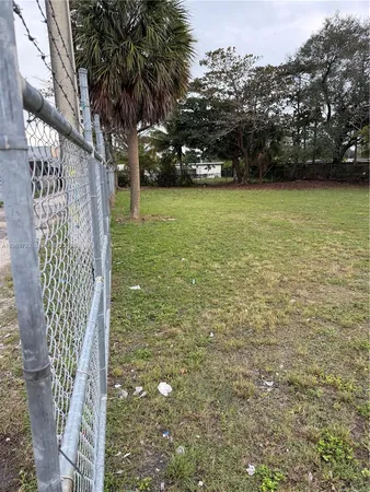 a view of a yard with yellow house
