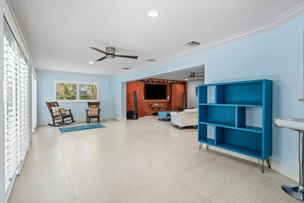 a living room with furniture and kitchen view