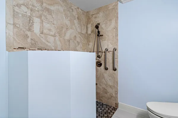 a bedroom with a bed a dresser and a window