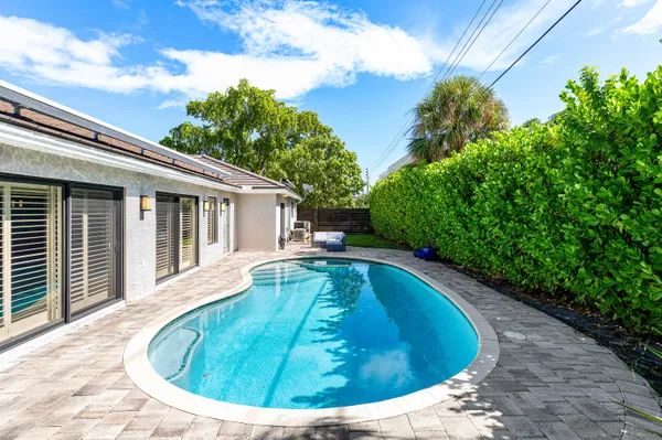 a view of a swimming pool and lounge chair