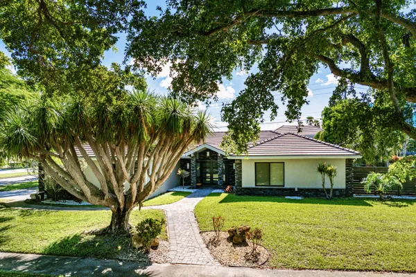 a view of a house with a yard and a garden