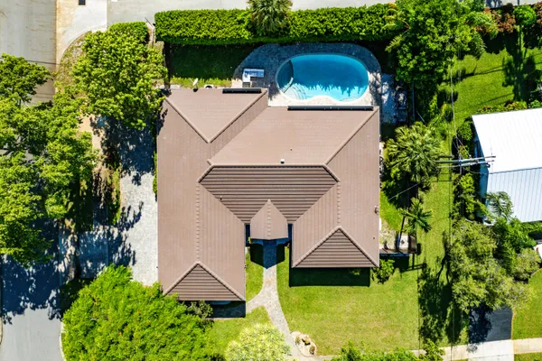 an aerial view of a house with garden space and street view