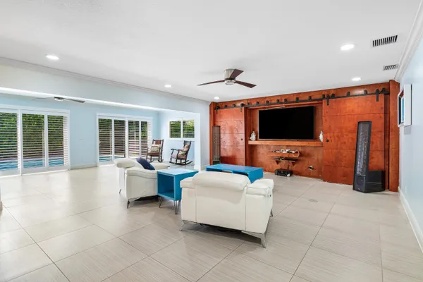 a kitchen with stainless steel appliances kitchen island granite countertop a refrigerator and a sink