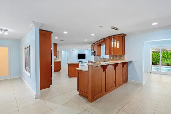 a kitchen with stainless steel appliances granite countertop a refrigerator and a stove top oven