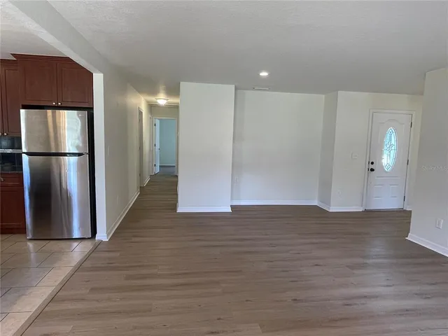 a view of a kitchen with a refrigerator and a stove