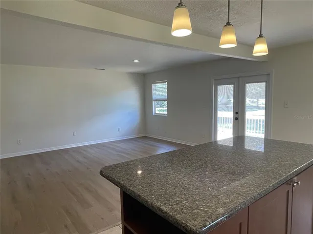 an open kitchen with granite countertop sink and dishwasher