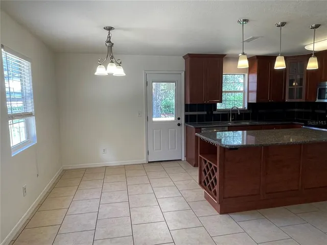a kitchen with a counter space a sink and cabinets