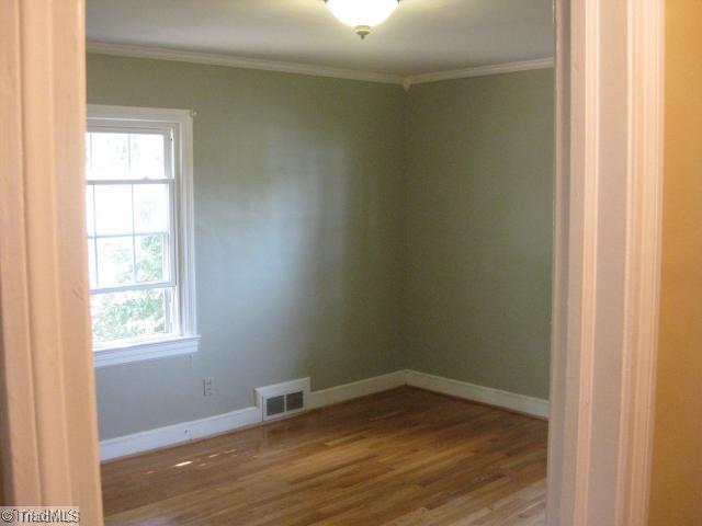 150 Cook Street Rural Hall, NC 27045 - Photo 8 of 15 1st Bedroom. This is the Master bedroom located on the main level, with real hardwoods, nice crown moldings, and a ceramic tile shower in bath.