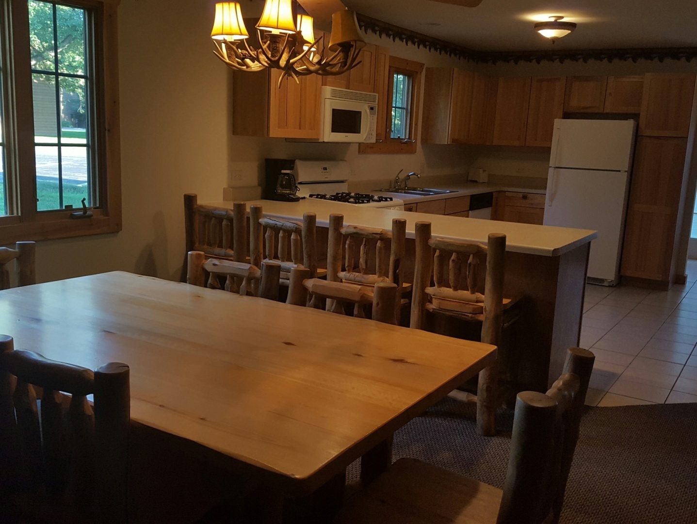2643 North Illinois Rt 178 Road, Unit I4 Utica, IL 61373 - Photo 2 of 23 a kitchen with stainless steel appliances a stove a sink a refrigerator a dining table and chairs