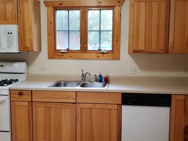 a kitchen with stainless steel appliances a sink a stove and a microwave