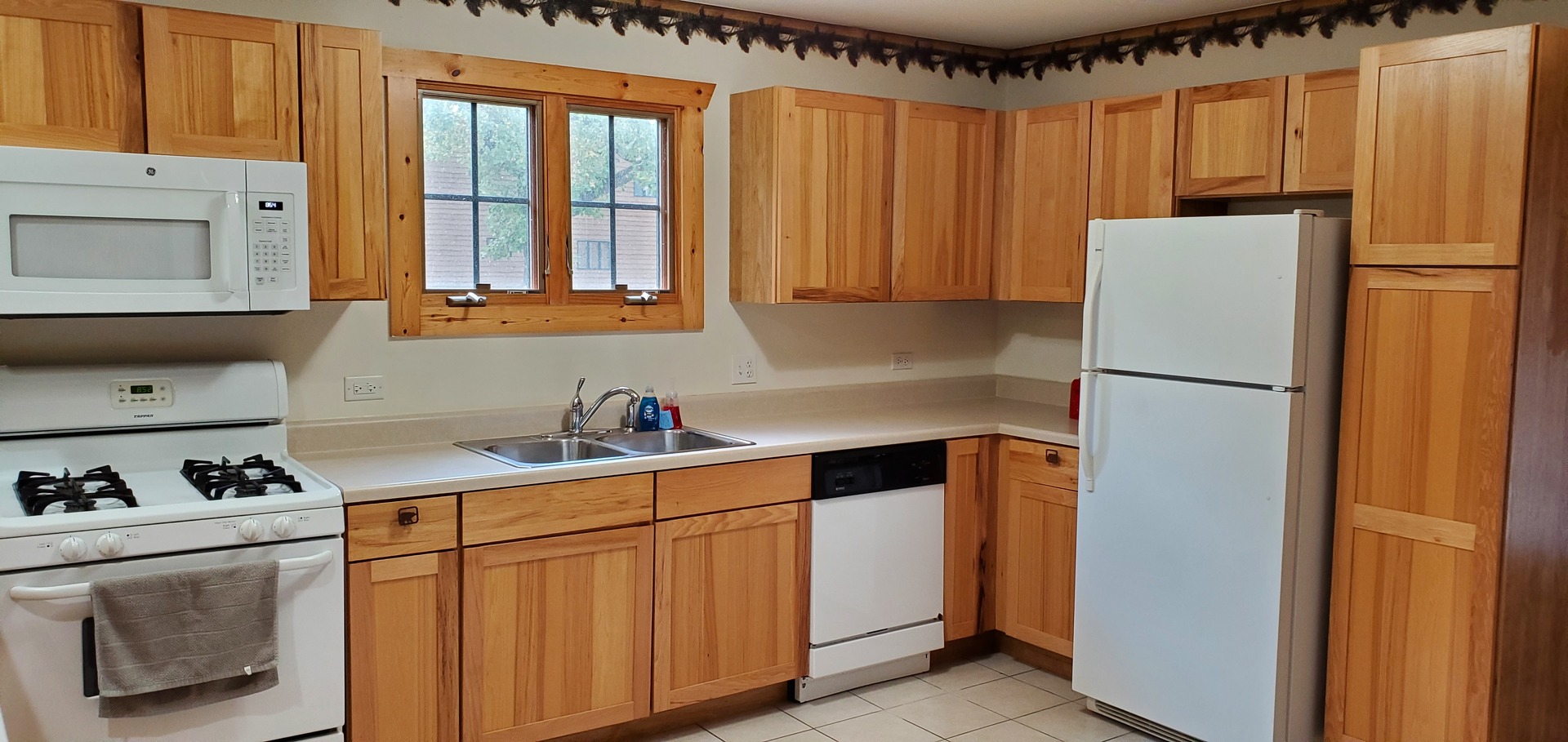 2643 North Illinois Rt 178 Road, Unit I4 Utica, IL 61373 - Photo 9 of 21 a kitchen with a refrigerator a stove a sink and a window