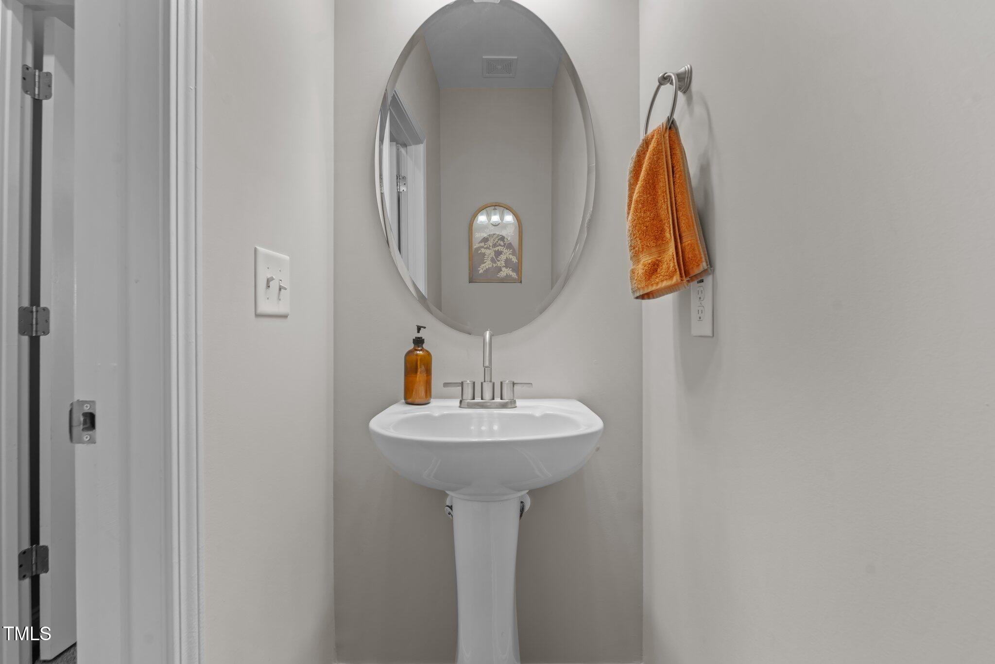 784 Cypress Road Cameron, NC 28326 - Photo 2 of 3 a bathroom with a sink and a mirror