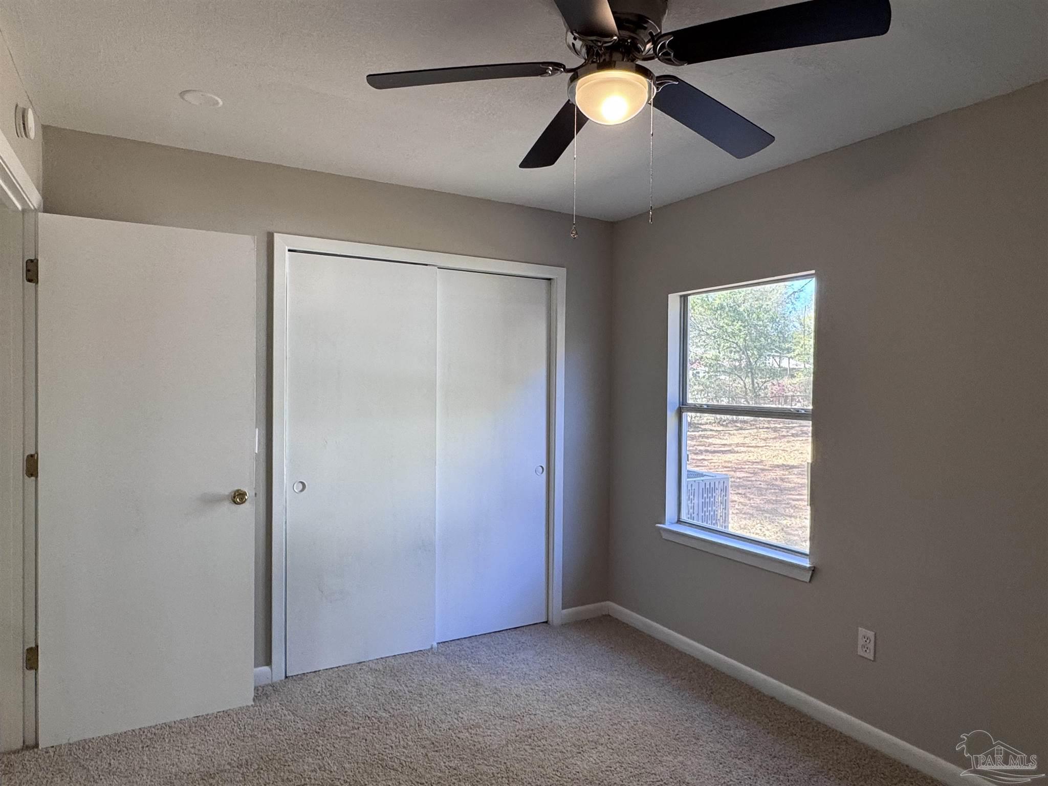 6426 Walnut Street Milton, FL 32570 - Photo 15 of 21 an empty room with windows and fan