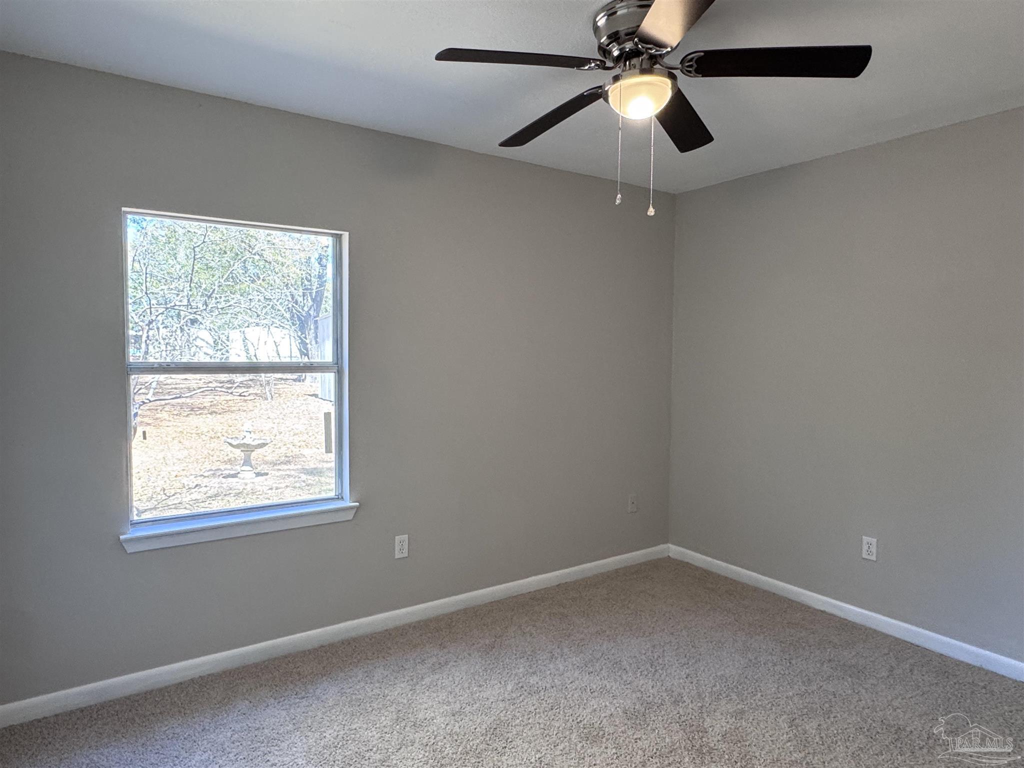 6426 Walnut Street Milton, FL 32570 - Photo 16 of 21 an empty room with a window and a fan