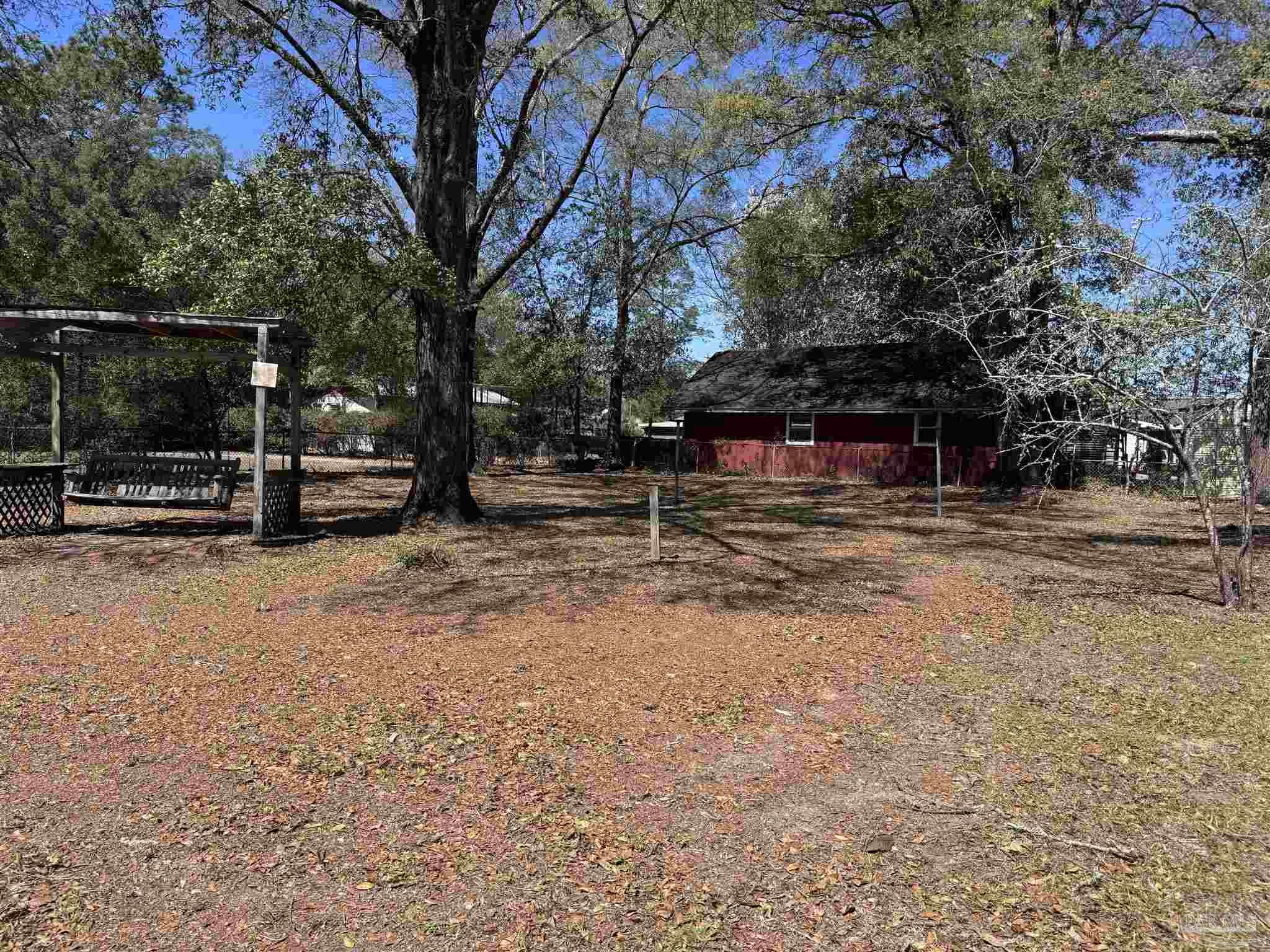 6426 Walnut Street Milton, FL 32570 - Photo 17 of 21 a view of outdoor space with deck and tree