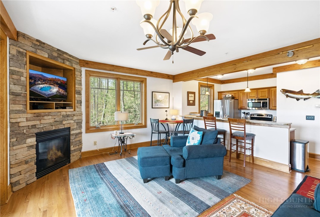 142 Evening View Lane, Unit CA4 Boone, NC 28607 - Photo 11 of 36 a living room with fireplace furniture and a flat screen tv