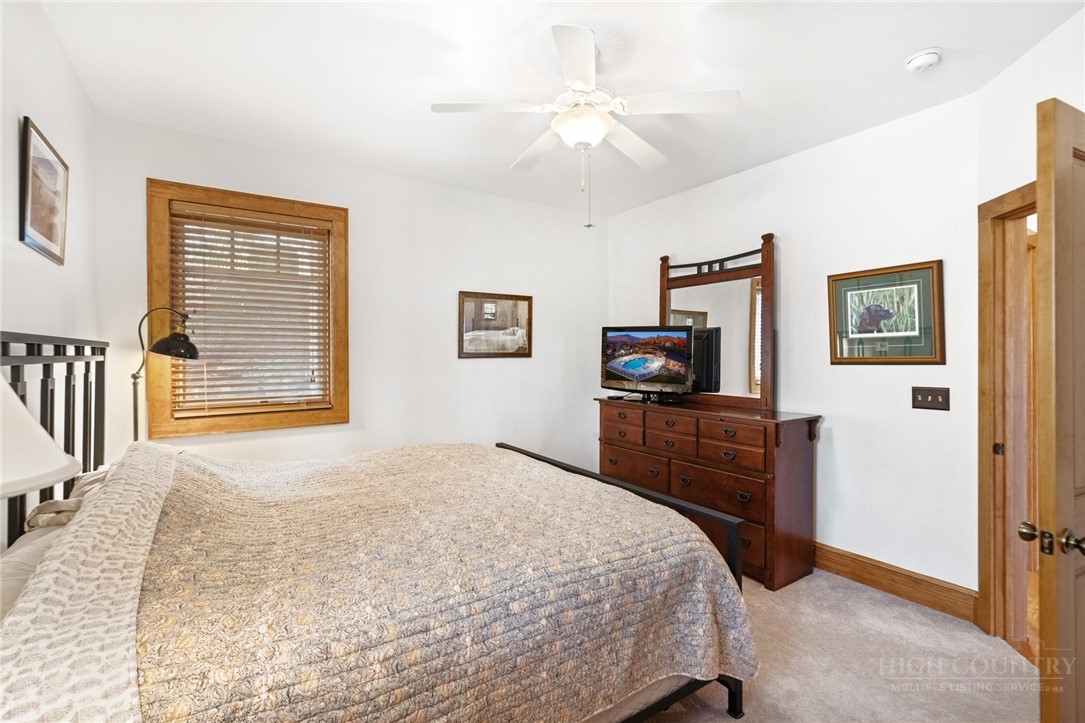 142 Evening View Lane, Unit CA4 Boone, NC 28607 - Photo 21 of 36 a bedroom with a bed and a flat screen tv