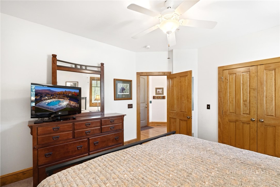 142 Evening View Lane, Unit CA4 Boone, NC 28607 - Photo 23 of 36 a bedroom with a bed and a flat screen tv
