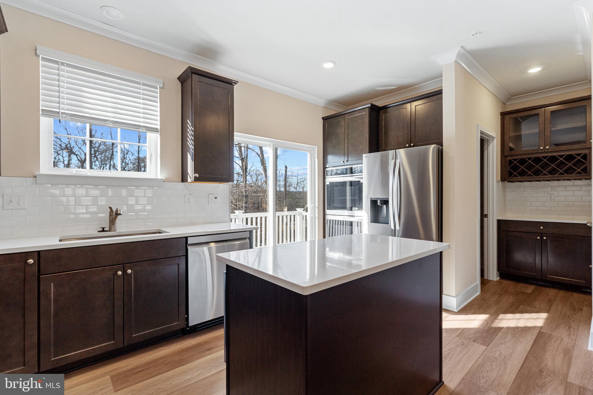 1730 Water Xing Road Baltimore, MD 21208 - Photo 12 of 33 a kitchen with stainless steel appliances granite countertop a refrigerator and a sink