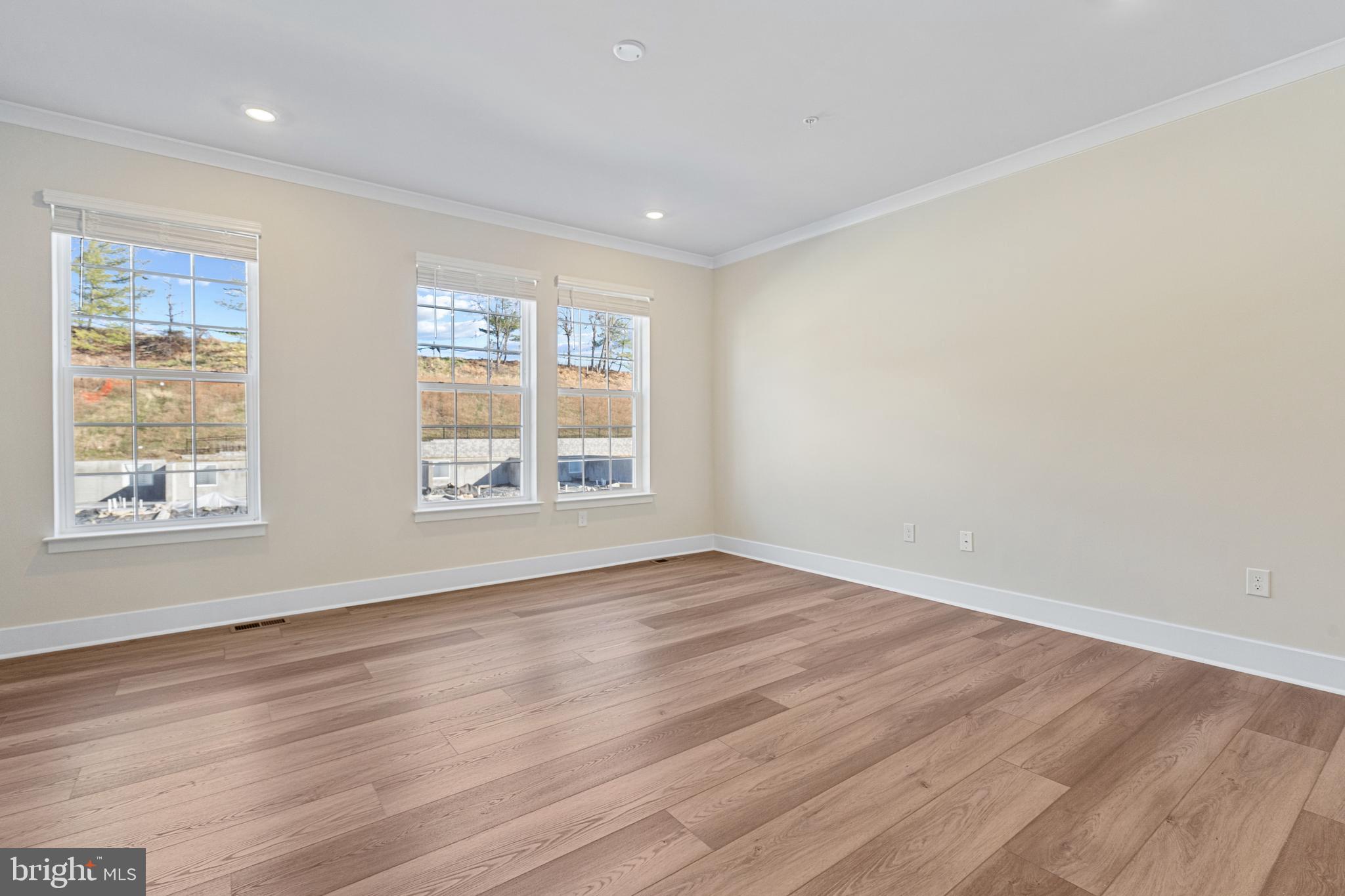 1730 Water Xing Road Baltimore, MD 21208 - Photo 3 of 33 a view of an empty room with wooden floor and a window
